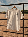 Clutch & Twist motel t-shirt hanging on a ranch gate