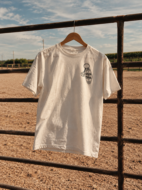 Clutch & Twist motel t-shirt hanging on a ranch gate